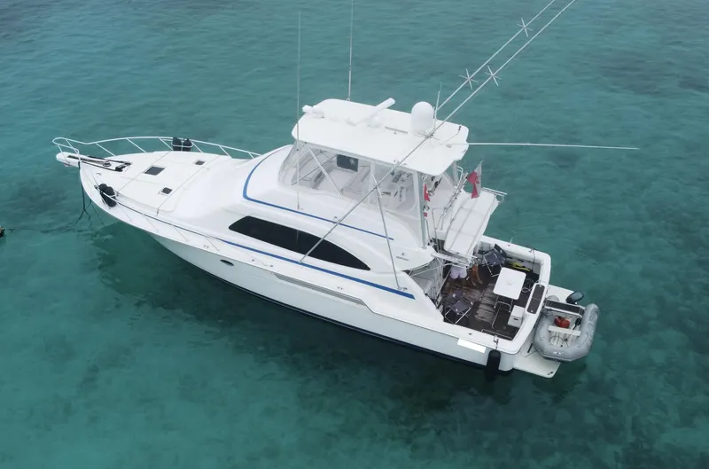  Yacht Photos Pics 2005 Bertram 510 yacht on clear turquoise water, aerial view.