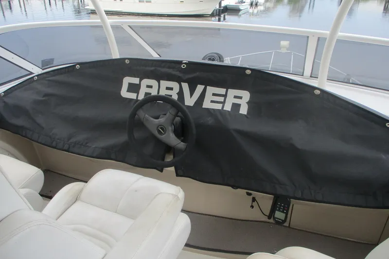  Yacht Photos Pics 2006 Carver 466 Motor Yacht helm with protective cover and steering wheel.