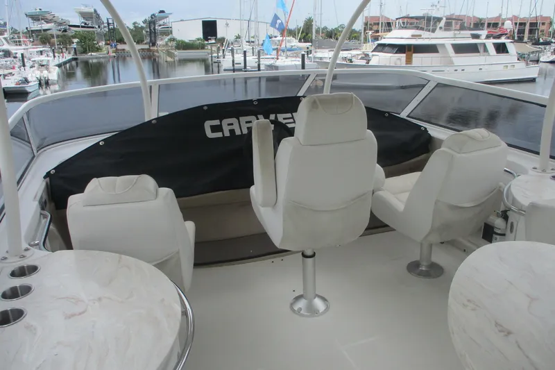  Yacht Photos Pics 2006 Carver 466 Motor Yacht interior with white seating and marina view.