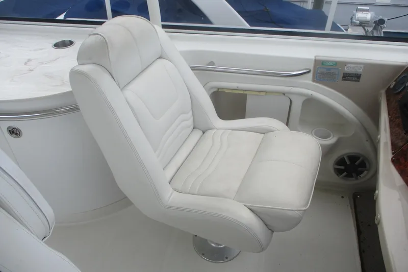  Yacht Photos Pics White captain's chair on 2006 Carver 466 Motor Yacht, featuring sleek design and comfortable seating.