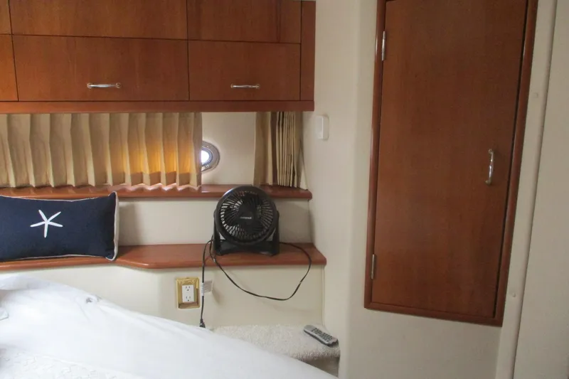  Yacht Photos Pics Interior cabin of 2006 Carver 466 Motor Yacht with wooden cabinetry and nautical decor.