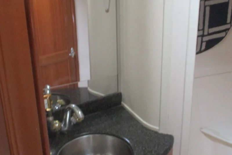  Yacht Photos Pics Bathroom interior of 2006 Carver 466 Motor Yacht with sink and mirror.