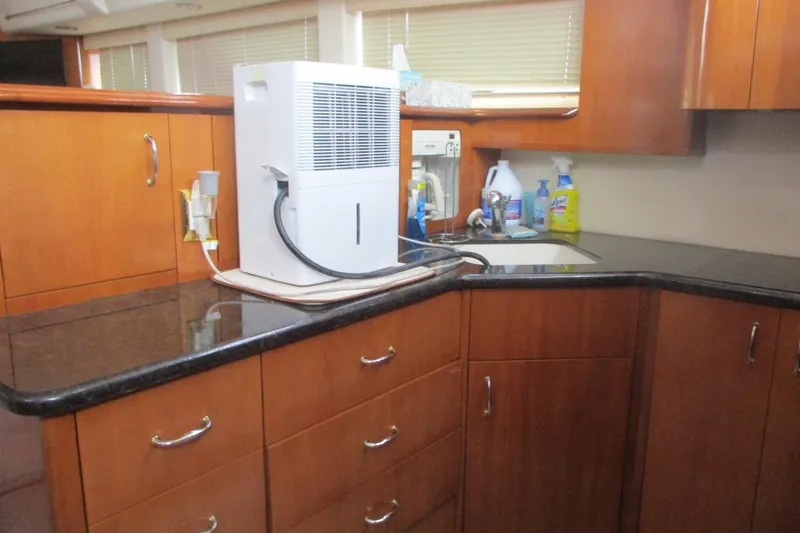  Yacht Photos Pics 2006 Carver 466 Motor Yacht kitchen with wooden cabinets and countertop appliances.