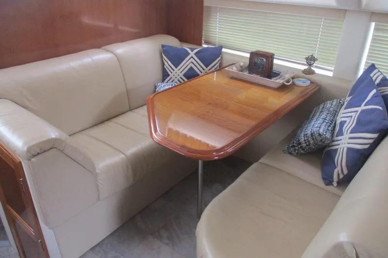  Yacht Photos Pics Interior of 2006 Carver 466 Motor Yacht with beige seating and wooden table.