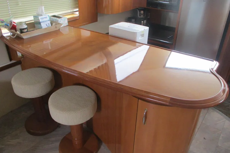  Yacht Photos Pics Interior of 2006 Carver 466 Motor Yacht with polished wooden bar and stools.