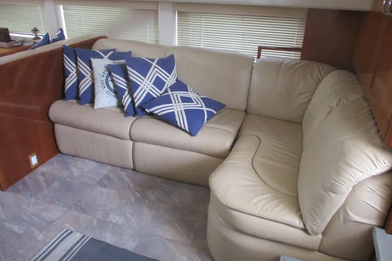  Yacht Photos Pics Luxurious beige leather sofa with blue patterned pillows in 2006 Carver 466 Motor Yacht.