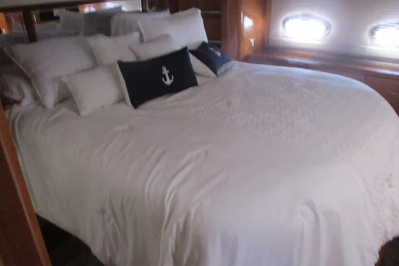  Yacht Photos Pics Luxurious bedroom in 2006 Carver 466 Motor Yacht with nautical-themed decor.