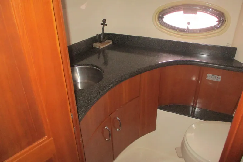  Yacht Photos Pics Luxurious bathroom in 2006 Carver 466 Motor Yacht with granite countertop and porthole window.