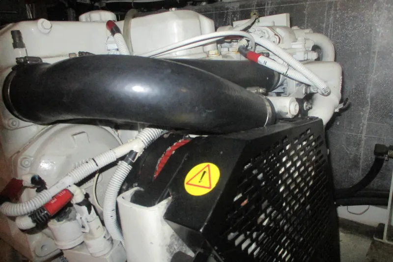  Yacht Photos Pics Engine compartment of a 2006 Carver 466 Motor Yacht, featuring hoses and warning label.