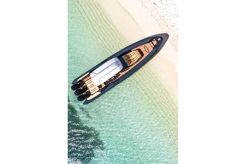  Yacht Photos Pics Aerial view of 2018 Bernico RX 10 boat on clear turquoise water near sandy beach.