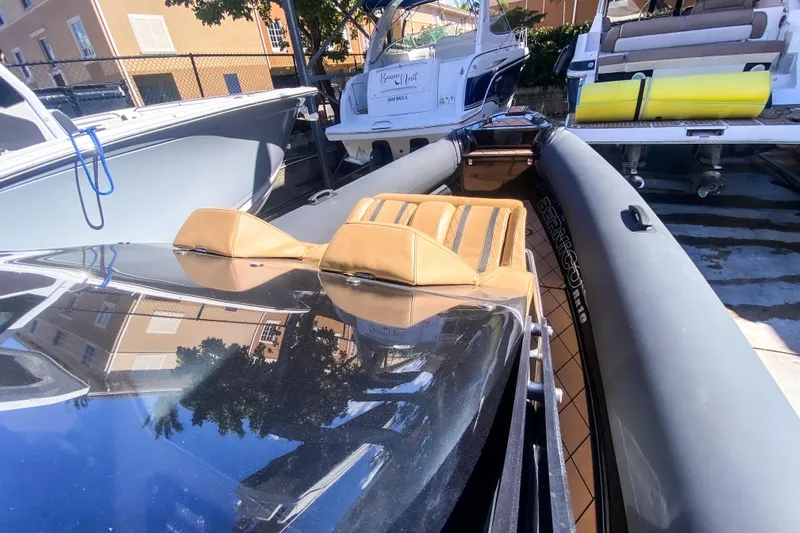  Yacht Photos Pics 2018 Bernico RX 10 boat with tan seats and sleek design in a marina setting.