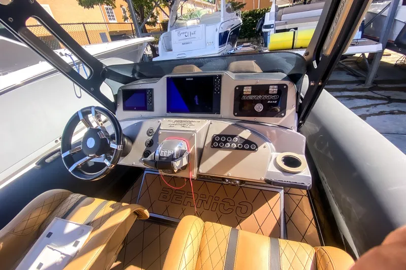  Yacht Photos Pics Interior of a 2018 Bernico RX 10 boat with modern dashboard and steering wheel.