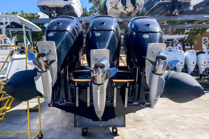  Yacht Photos Pics Triple outboard motors on a 2018 Bernico RX 10 boat, displayed outdoors.