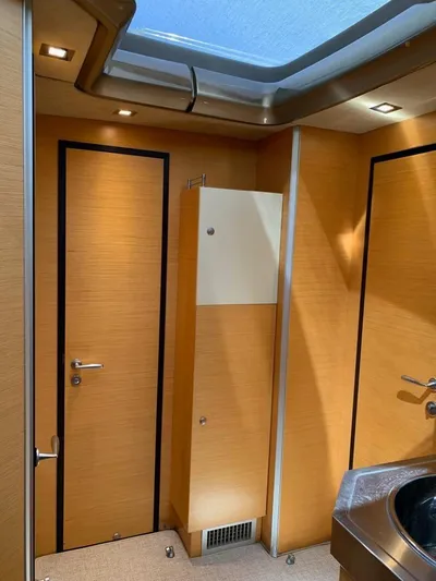 Family Affair Yacht Photos Pics Interior of 2011 Cranchi 43 Atlantique yacht with wooden paneling and modern fixtures.