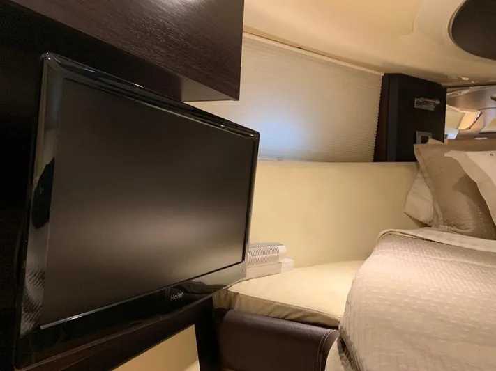 Family Affair Yacht Photos Pics Interior cabin of 2011 Cranchi 43 Atlantique yacht with TV and bed.