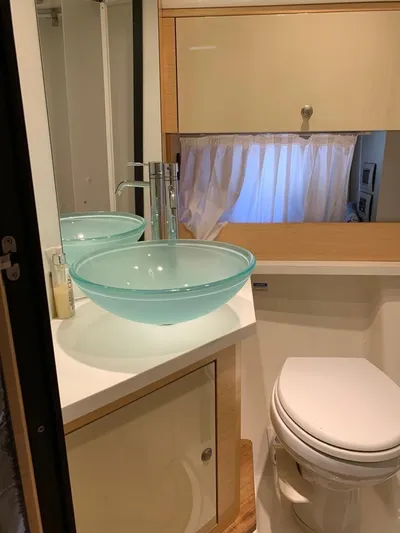 Family Affair Yacht Photos Pics Modern bathroom in 2011 Cranchi 43 Atlantique yacht with glass sink and toilet.