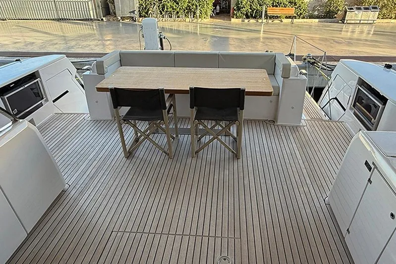 Karya Yacht Photos Pics Luxury deck of 2023 Ferretti Yachts 780 with wooden table and chairs.