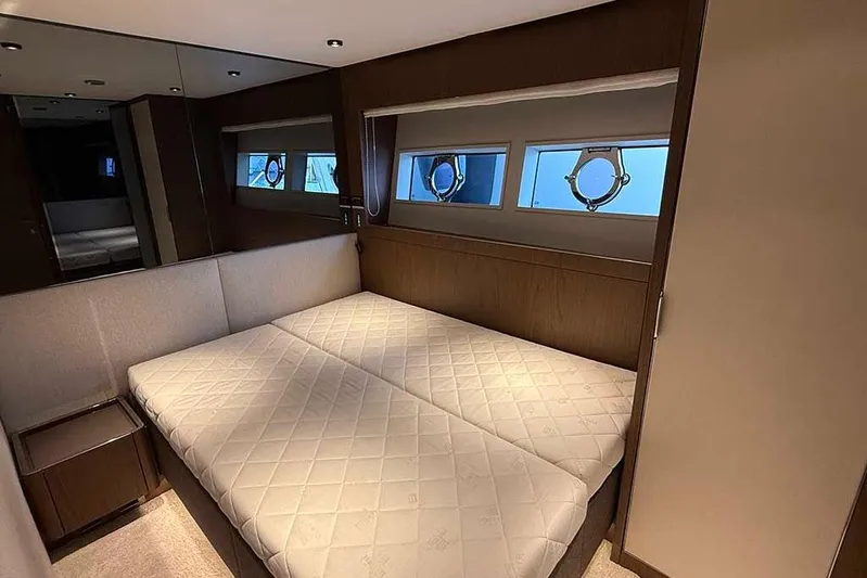 Karya Yacht Photos Pics Luxurious bedroom interior of 2023 Ferretti Yachts 780 with elegant design and porthole windows.