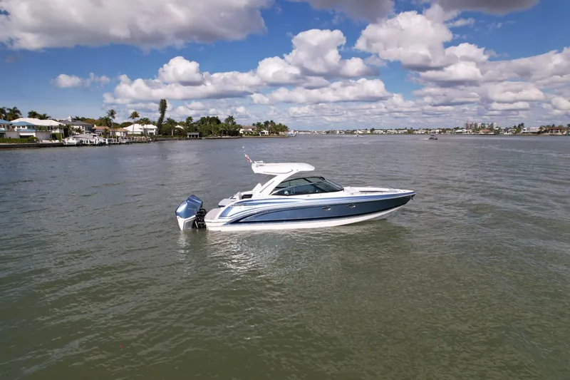 Sea Smoke Yacht Photos Pics 2023 Formula 330 CBR boat on calm water under blue sky.