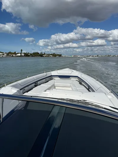 Sea Smoke Yacht Photos Pics 2023 Formula 330 CBR boat on calm water under blue sky.