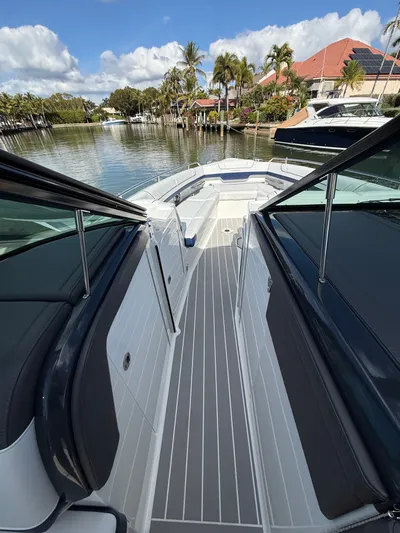 Sea Smoke Yacht Photos Pics 2023 Formula 330 CBR boat on calm water with palm trees.