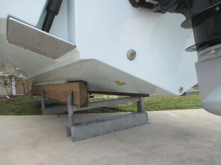 Yacht Photos Pics 2023 Sea Fox 328 Commander boat hull on a metal stand, viewed from below.