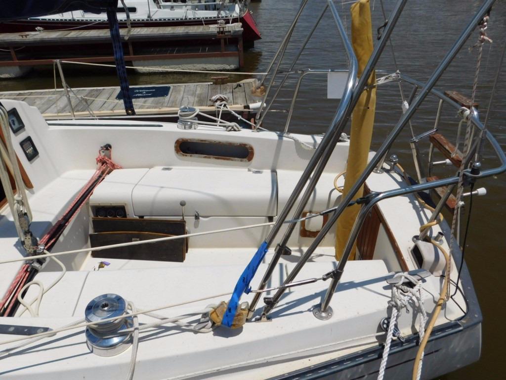 1981 Pearson 32 sailboat cockpit with ropes and winches at a marina.