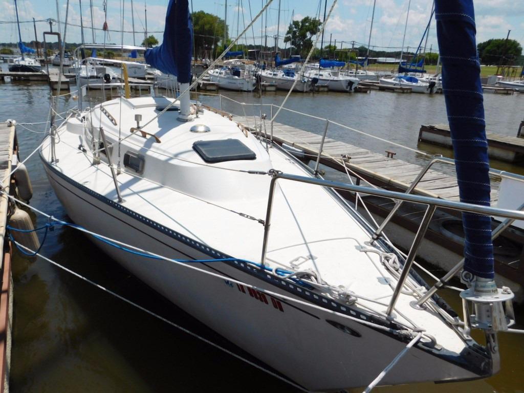 1981 Pearson 32 sailboat docked at a marina, surrounded by other boats.