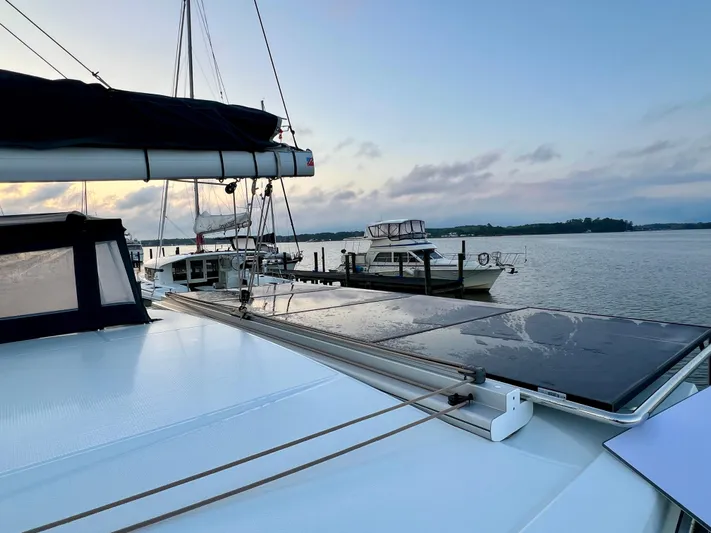 Amihan Yacht Photos Pics 2023 Fountaine Pajot Isla 40 catamaran docked at sunset with solar panels visible.