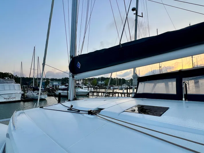Amihan Yacht Photos Pics 2023 Fountaine Pajot Isla 40 catamaran docked at sunset, showcasing sleek design and marina backdrop.