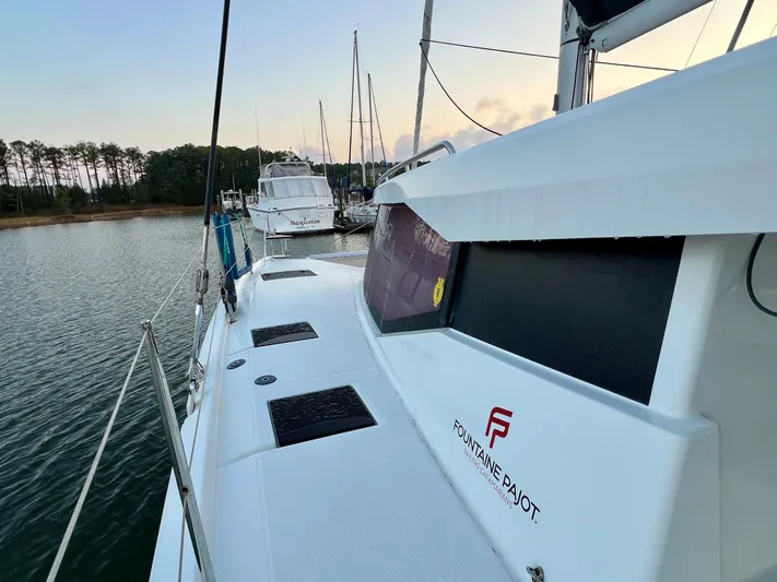 Amihan Yacht Photos Pics 2023 Fountaine Pajot Isla 40 catamaran docked in a serene marina setting.