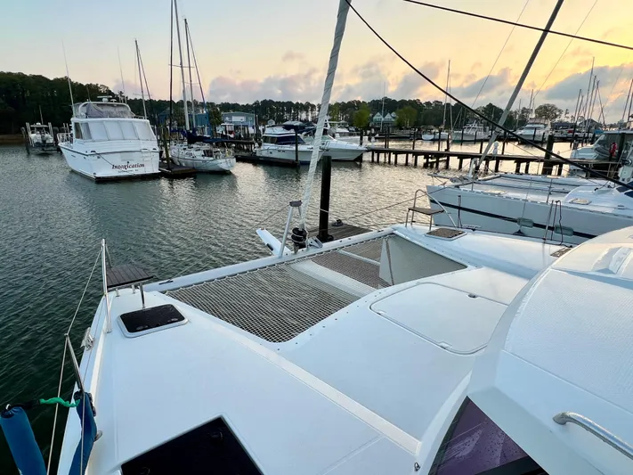 Amihan Yacht Photos Pics 2023 Fountaine Pajot Isla 40 catamaran docked at a marina during sunset.
