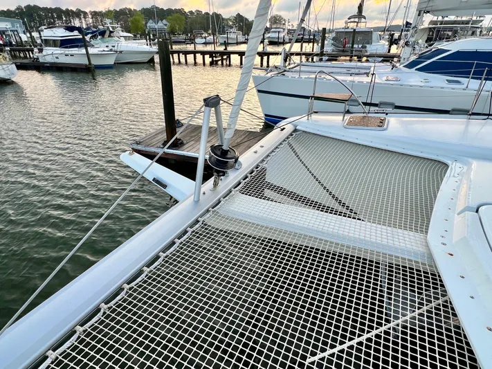 Amihan Yacht Photos Pics 2023 Fountaine Pajot Isla 40 catamaran docked at a marina, showcasing its netted deck.