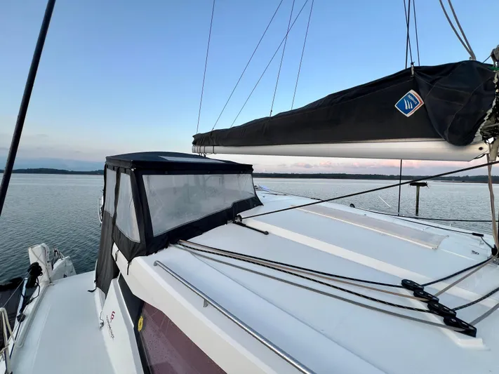 Amihan Yacht Photos Pics 2023 Fountaine Pajot Isla 40 catamaran on calm water at sunset.