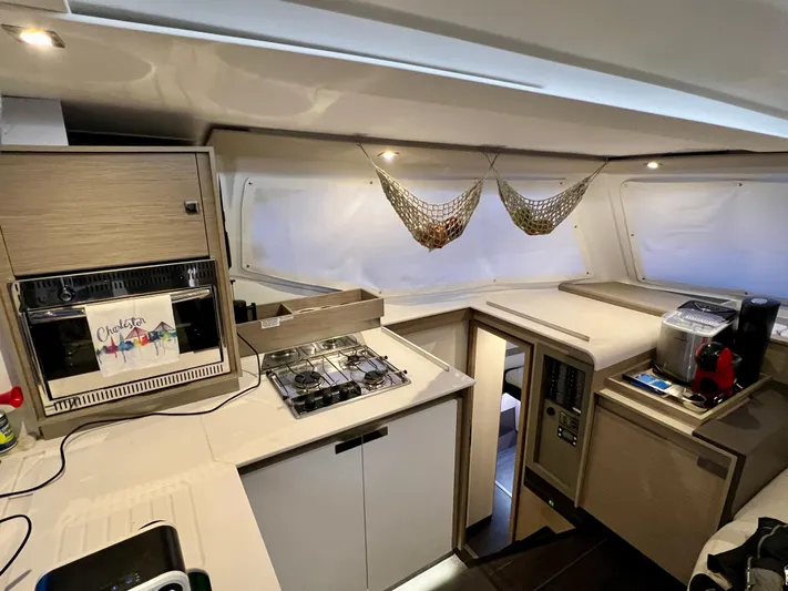 Amihan Yacht Photos Pics Modern kitchen interior of 2023 Fountaine Pajot Isla 40 catamaran with appliances and storage.