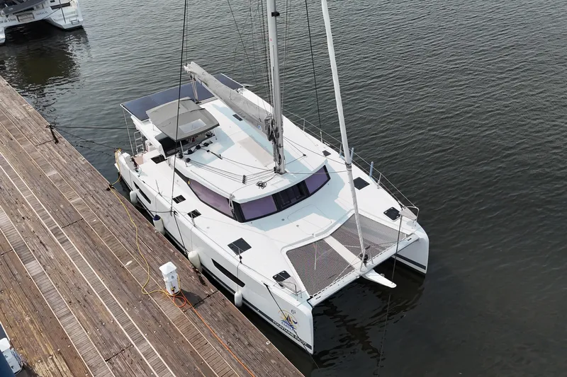 Amihan Yacht Photos Pics 2023 Fountaine Pajot Isla 40 catamaran docked at a marina, aerial view.