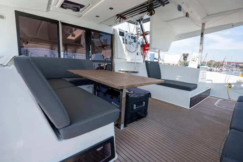 Amihan Yacht Photos Pics 2023 Fountaine Pajot Isla 40 yacht interior with seating and wooden table.