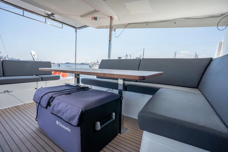 Amihan Yacht Photos Pics 2023 Fountaine Pajot Isla 40 yacht deck with seating and table, overlooking the sea.