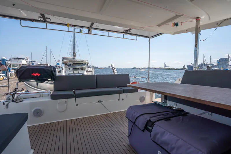 Amihan Yacht Photos Pics 2023 Fountaine Pajot Isla 40 catamaran interior with docked boats in marina view.