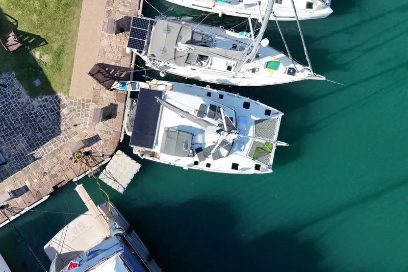 Amihan Yacht Photos Pics Aerial view of 2023 Fountaine Pajot Isla 40 catamaran docked in a marina.
