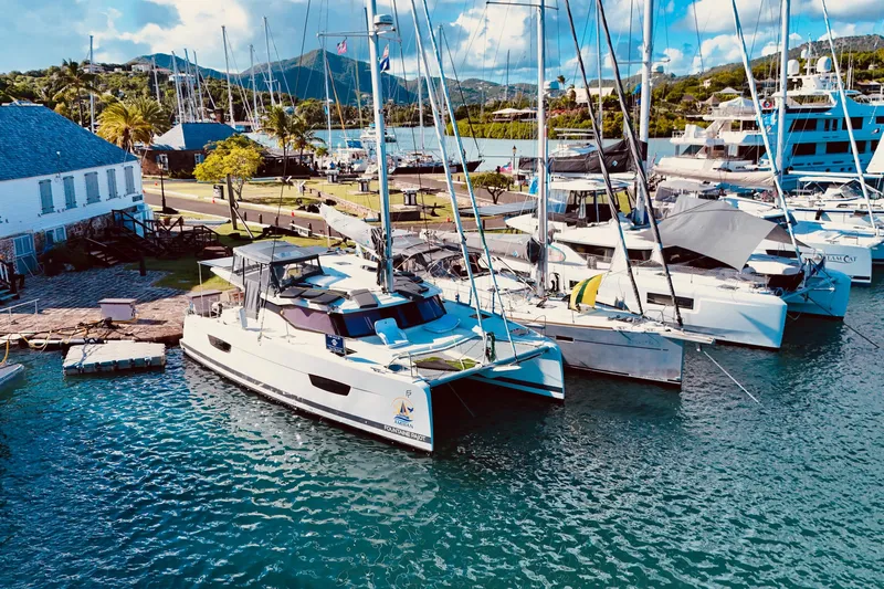 Amihan Yacht Photos Pics 2023 Fountaine Pajot Isla 40 catamaran docked in a scenic marina setting.