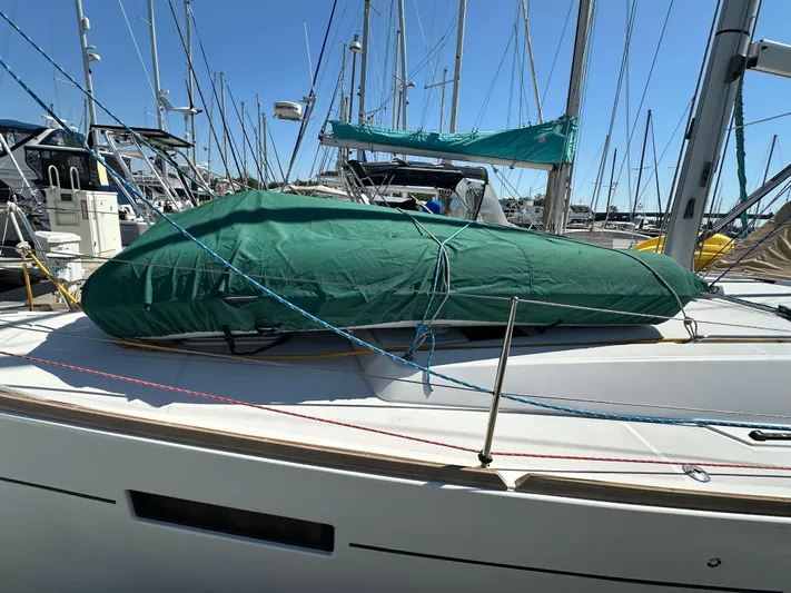 Yes My Dear Yacht Photos Pics 2012 Beneteau Oceanis 41 sailboat with green cover, docked in a marina.