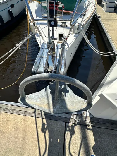 Yes My Dear Yacht Photos Pics 2012 Beneteau Oceanis 41 sailboat anchored at a marina, showcasing its anchor and bow.