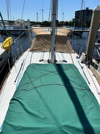 Yes My Dear Yacht Photos Pics 2012 Beneteau Oceanis 41 sailboat docked, featuring green and tan covers.