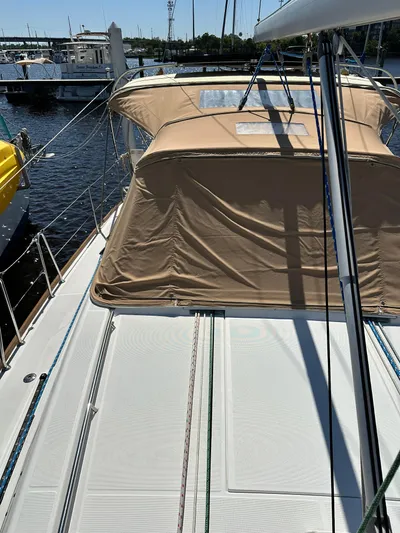 Yes My Dear Yacht Photos Pics 2012 Beneteau Oceanis 41 sailboat with tan canopy, docked at marina.