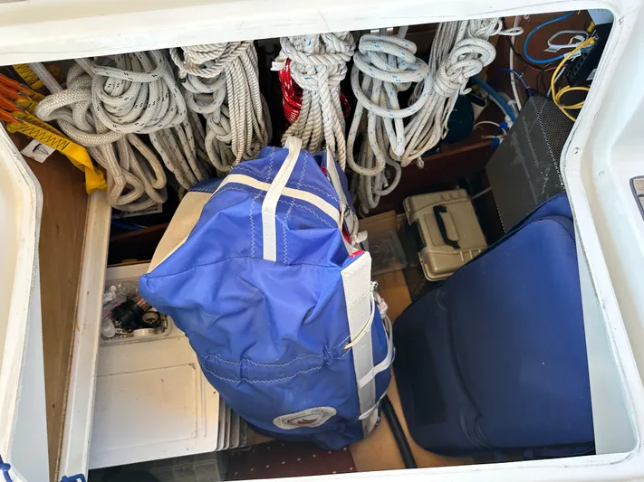 Yes My Dear Yacht Photos Pics Storage compartment of a 2012 Beneteau Oceanis 41 with ropes and a blue bag.