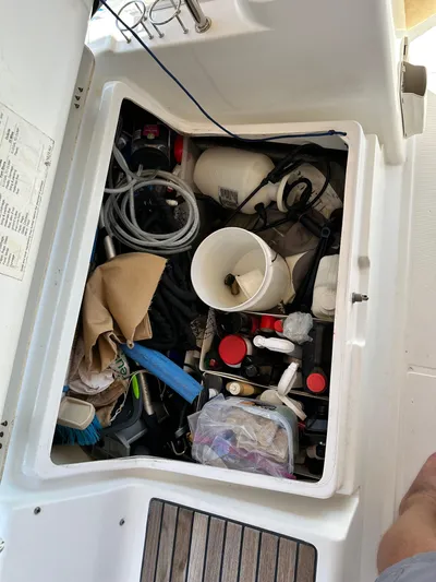 Yes My Dear Yacht Photos Pics Storage compartment on a 2012 Beneteau Oceanis 41 sailboat, filled with various boating supplies.