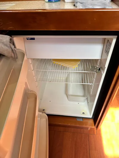 Yes My Dear Yacht Photos Pics Open fridge inside 2012 Beneteau Oceanis 41 yacht, showing interior shelves and freezer compartment.