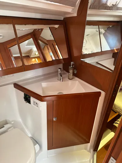 Yes My Dear Yacht Photos Pics Beneteau Oceanis 41 (2012) bathroom with wooden cabinetry and modern fixtures.