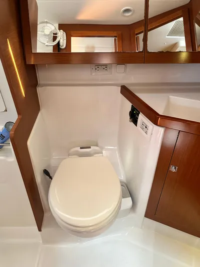 Yes My Dear Yacht Photos Pics Beneteau Oceanis 41 (2012) yacht bathroom with modern fixtures and wooden cabinetry.